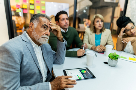 older person in a meeting in a conference room