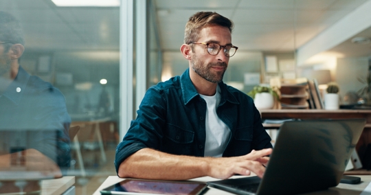 employee working on his laptop in the office